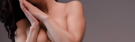 panoramic shot of sexy and naked woman isolated on grey