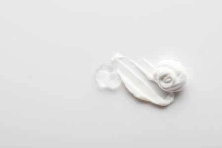 Top view of cosmetic cream brushstrokes with gel on grey backgroundの写真素材