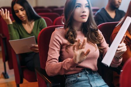 multiethnic actor and actresses reading scripts in theatreの写真素材
