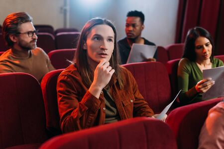 multicultural actors and actress reading scripts in theatre
