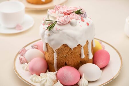 tasty fresh Easter cake with painted eggs and meringue on plate
