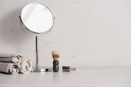 Towels, round mirror, shaving brush and razor on white background, zero waste conceptの写真素材
