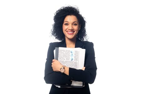 Front view of positive african american businesswoman with documents looking at camera isolated on...
