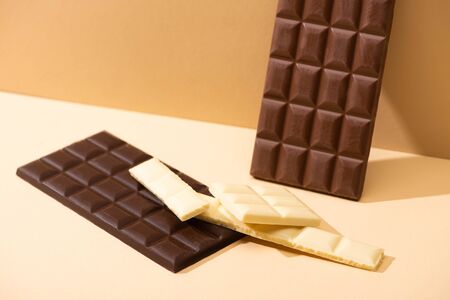 sweet delicious dark, milk and white chocolate on beige background