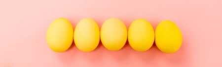 Panoramic view of Easter eggs on pink background, easter concept