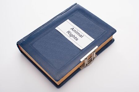 high angle view of blue book with animal rights inscription on white backgroundの写真素材