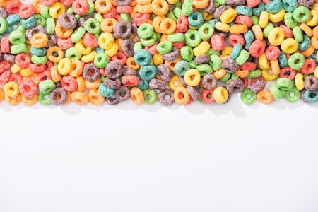 top view of bright multicolored breakfast cereal on white backgroundの写真素材
