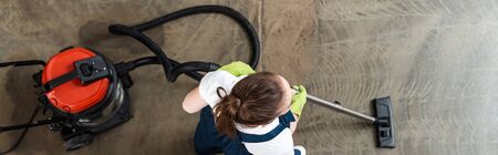 top view of cleaner vacuuming floor, panoramic shotの写真素材