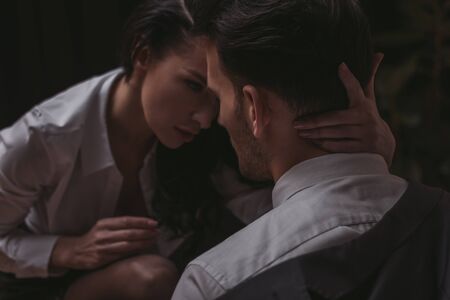beautiful, sensual secretary hugging neck of businessmanの写真素材