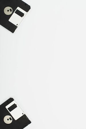 top view of two black diskettes on white background