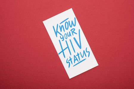 top view of card with know your HIV status lettering on red backgroundの写真素材