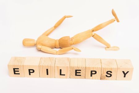 Selective focus of cubes with epilepsy lettering and wooden toy on white backgroundの写真素材
