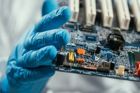 close up view of computer motherboard in hands on engineerの写真素材