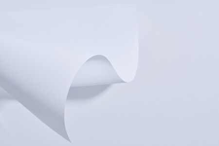 close up view of curved paper sheet on white background