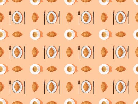 top view of cutlery, fresh croissants on plates and coffee on orange, seamless background patternの写真素材