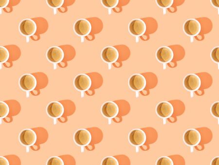 top view of cups of fresh coffee on orange, seamless background patternの写真素材