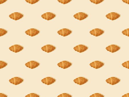 top view of fresh croissants on beige, seamless background patternの写真素材