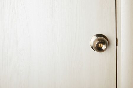 clean white wooden door with metal handle after disinfectionの写真素材