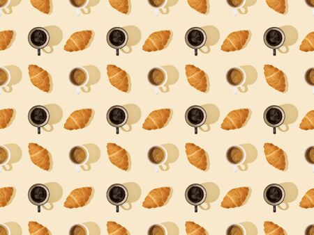 top view of croissants and coffee on beige, seamless background patternの写真素材