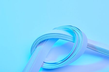 close up view of paper stripes on neon blue backgroundの写真素材