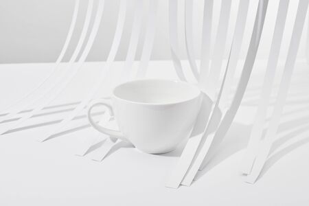 close up view of paper stripes and cup on white backgroundの写真素材