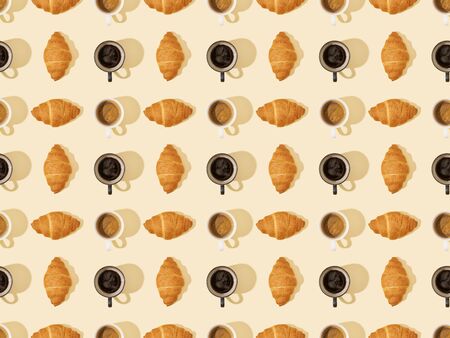 top view of croissants and coffee on beige, seamless background patternの写真素材