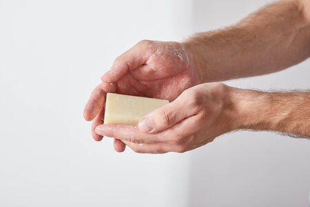 partial view of man using soap on grey background backgroundの写真素材
