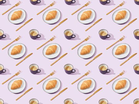golden forks and knives, croissants and coffee on violet, seamless background patternの写真素材