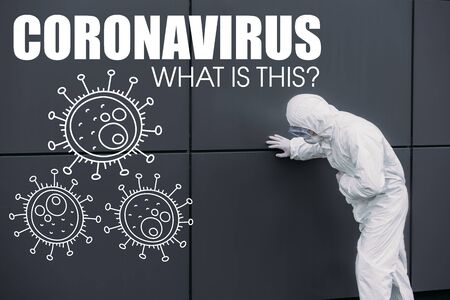 asian epidemiologist in hazmat suit leaning on wall while suffering from symptomatic abdominal pain, coronavirus illustrationの写真素材