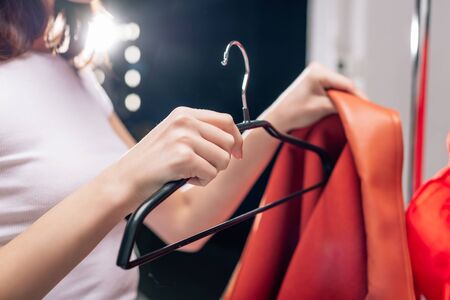cropped view of stylist holding hanger and jacket in photo studio