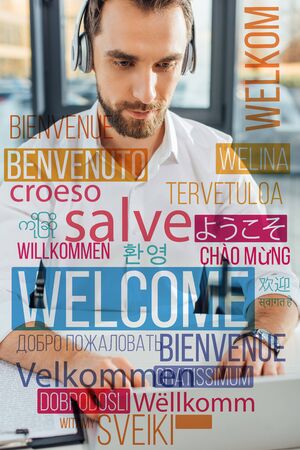 professional translator working online with headphones and laptop in office, welcome translation illustrationの写真素材