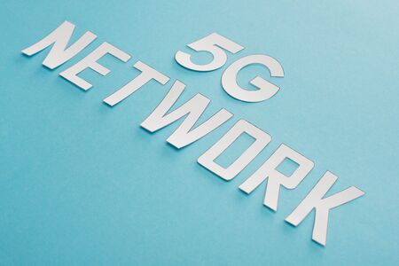 white 5g network lettering on blue backgroundの写真素材