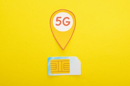 top view of sim card and 5g lettering on yellow backgroundの写真素材