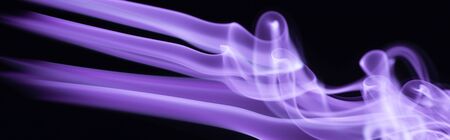 purple colorful flowing smoke on black background, panoramic shotの写真素材