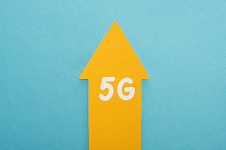 top view of 5g yellow arrow on blue background
