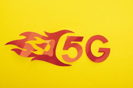 top view of red 5g with flame lettering on yellow backgroundの写真素材