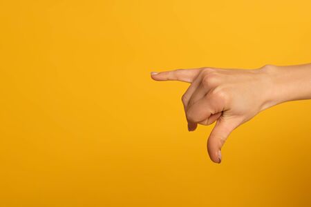 Cropped view of woman using deaf and dumb language isolated on yellow