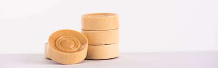 panoramic shot of wooden backgammon checkers isolated on whiteの写真素材