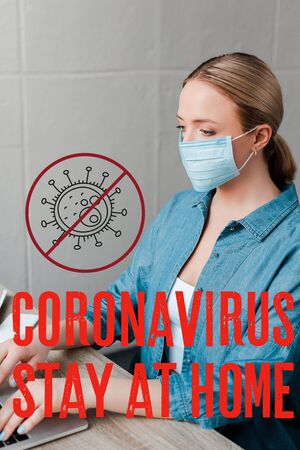 woman in medical mask working with laptop in office, coronavirus and stay at home illustrationの写真素材