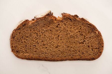 top view of fresh brown bread slice on white background