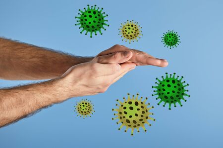 partial view of man washing hands isolated on blue, bacteria illustrationの写真素材