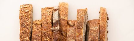 top view of tasty whole wheat bread slices on white background, panoramic shotの写真素材
