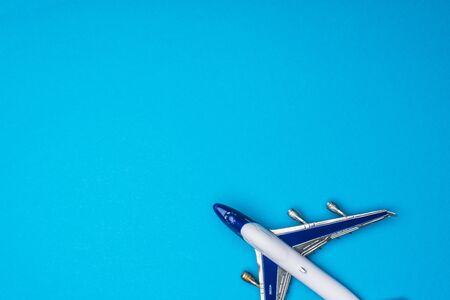 Top view of toy airplane on blue background with copy spaceの写真素材