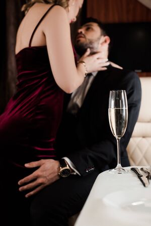 selective focus of man embracing sexy woman in planeの写真素材