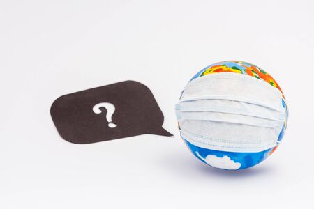 globe in protective medical mask near speech bubble with question mark on whiteの写真素材