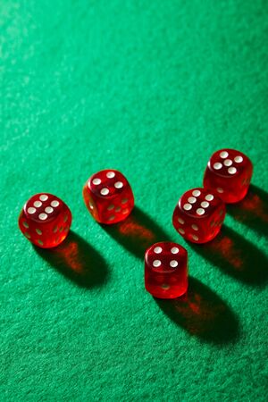 High angle view of red dice on green backgroundの写真素材