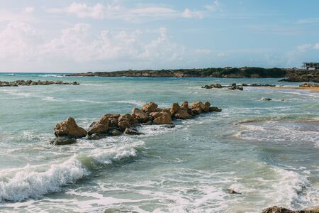 wet rocks in mediterranean sea against blue sky