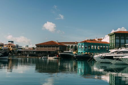 sunshine on buildings and docked yachts in mediterranean seaの写真素材