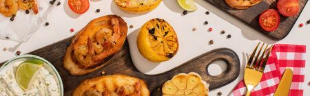 top view of canape with fried shrimps on wooden board with sauce on white background, panoramic shotの写真素材