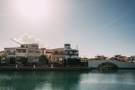 sunlight on houses near mediterranean sea against blue skyの写真素材